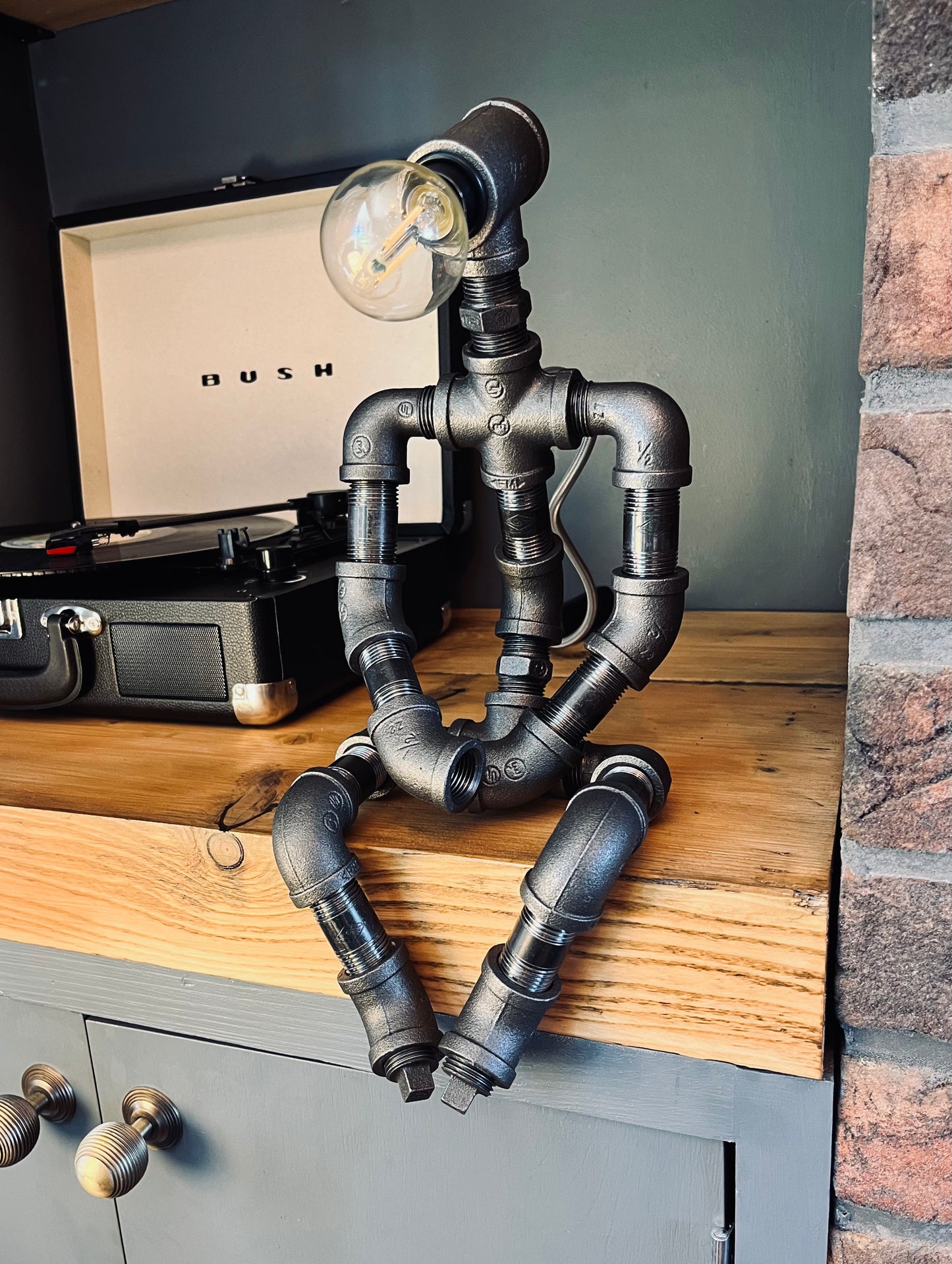 The Pensive Man Industrial Iron Pipe Man Robot Lamp & Modern White Bulb