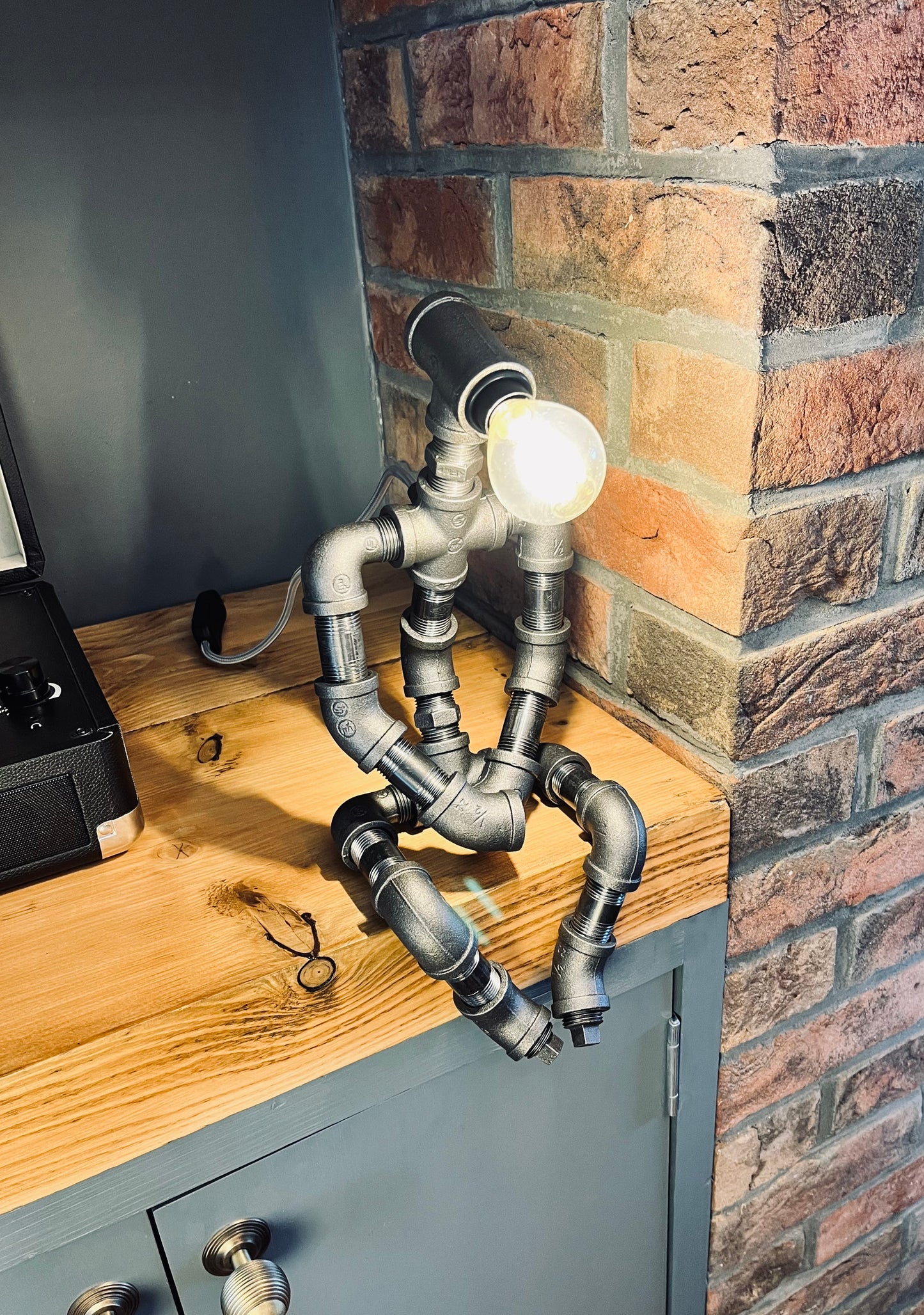 The Pensive Man Industrial Iron Pipe Man Robot Lamp & Modern White Bulb