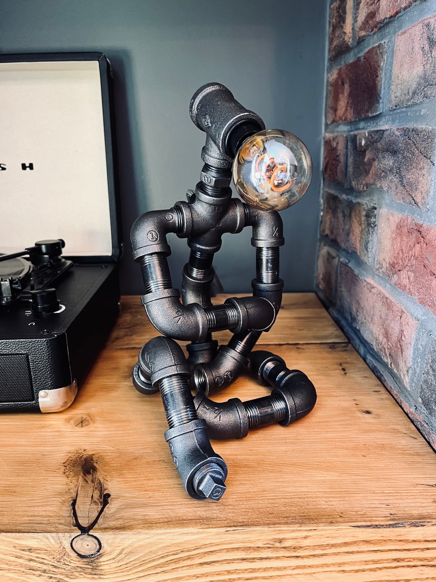 The Thinking Man Industrial Iron Pipe Person Robot Lamp & Vintage Bulb