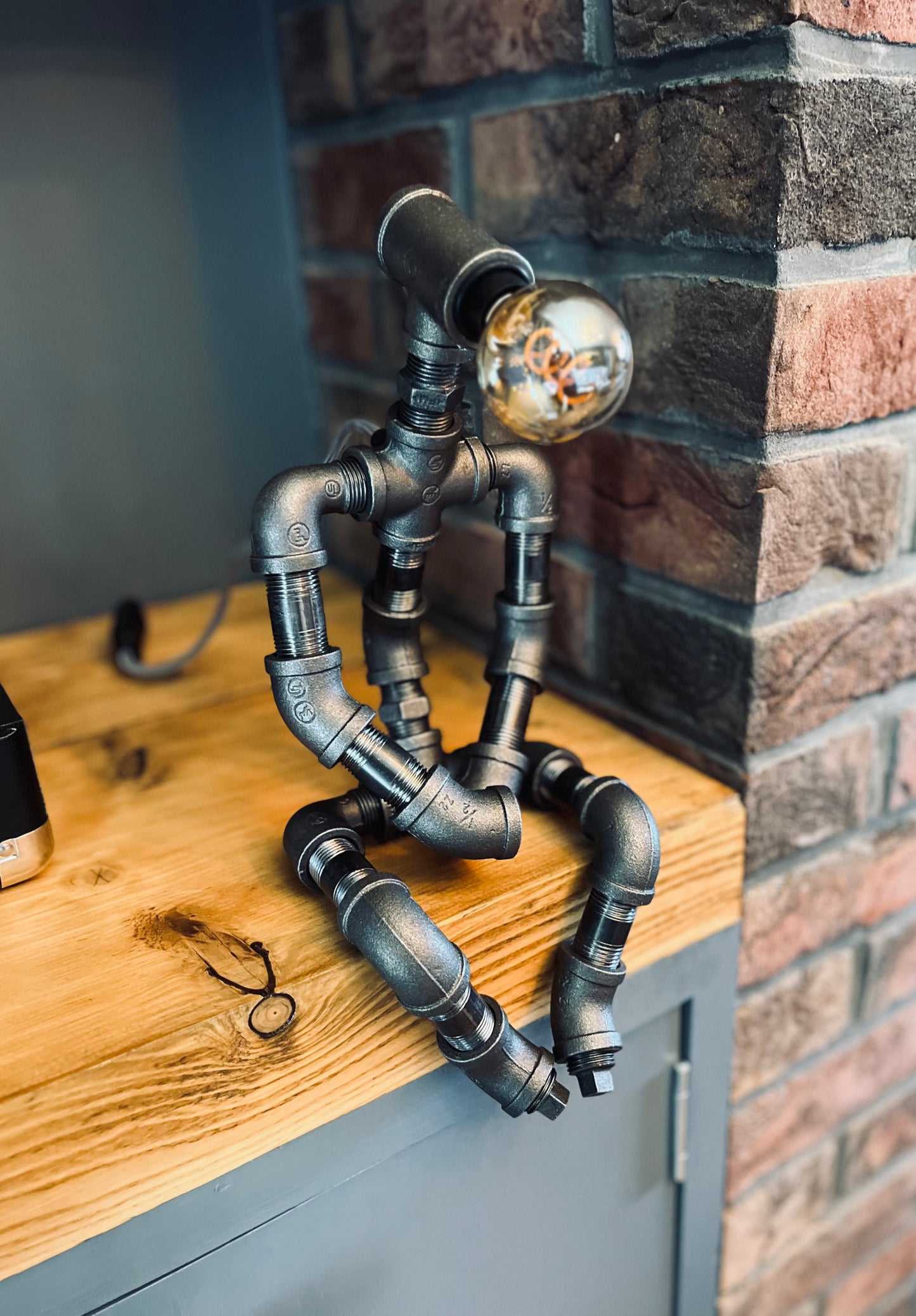 The Pensive Man Industrial Iron Pipe Man Robot Lamp & Vintage Bulb