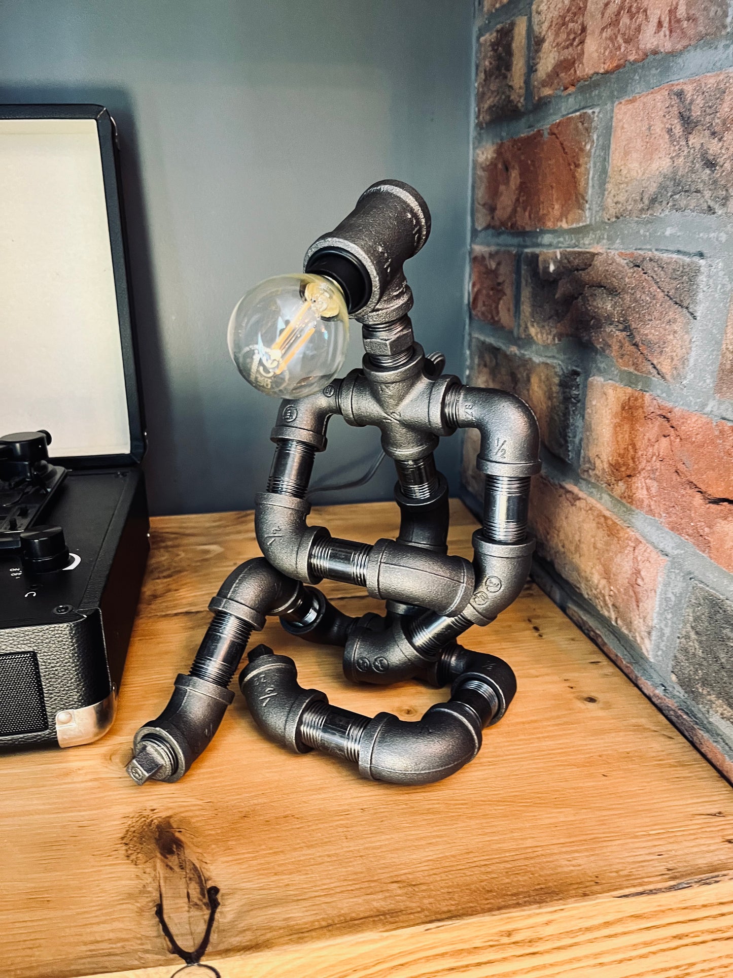 The Thinking Man Industrial Iron Pipe Person Robot Lamp & Modern White Bulb